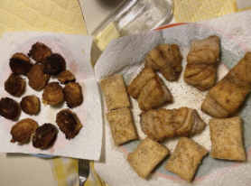 Hush Puppies on a plate with paper towels underneath 